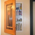 Hidden medicine cabinet behind picture frame