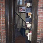 Hidden swing-in bookcase door reveals hidden stairs