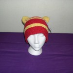 Hidden stash compartments in ears of knitted hat