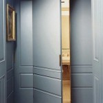 Hidden door behind wall panel