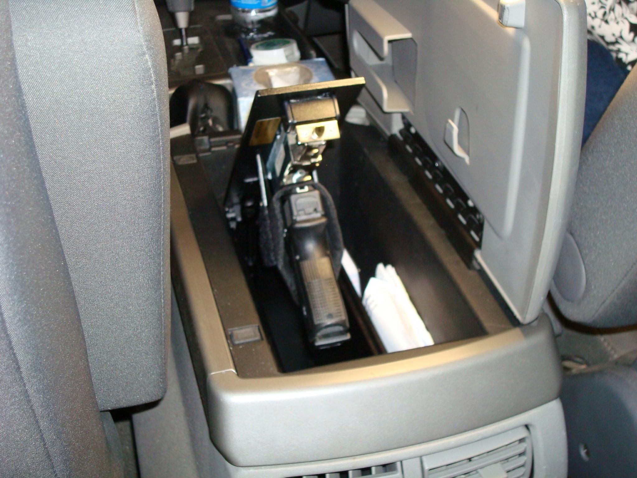 This user mounted a pop up gun safe to the center console of his
