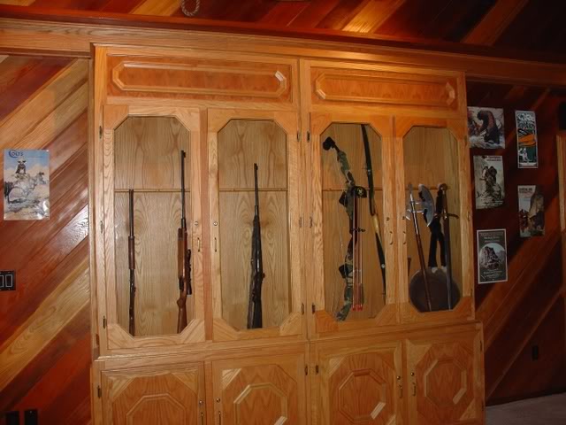 This gun cabinet door conceals a firing range behind. – Source: http 