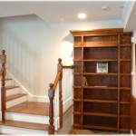 Hidden bookcase door at bottom of stairs