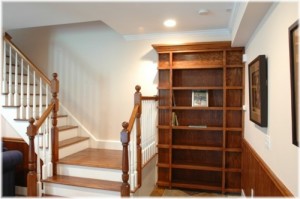Hidden bookcase door at bottom of stairs