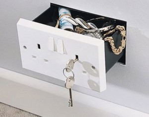 Hidden electrical outlet wall safe