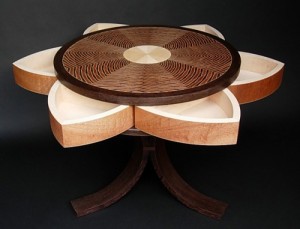 Hidden swing-out compartments in this Lotus Table