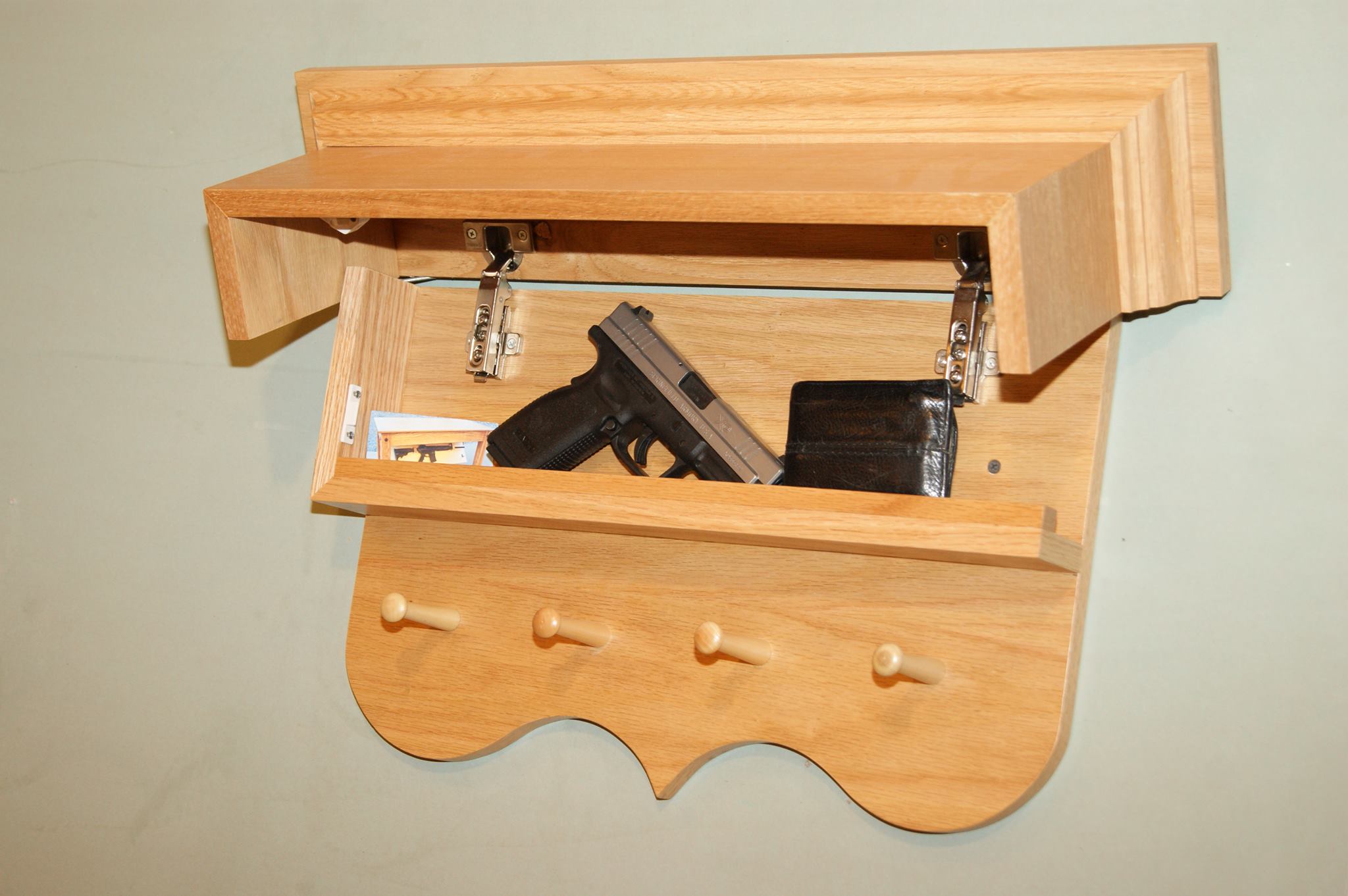 This shelf tilts up to reveal a hidden compartment inside. – Source 